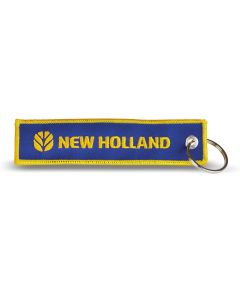 Brelok na klucze z niebieskiej tkaniny z wyszytym logo New Holland.