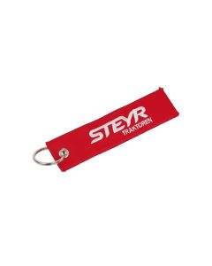 Brelok z czerwonego materiału z wyszytym logo STEYR.